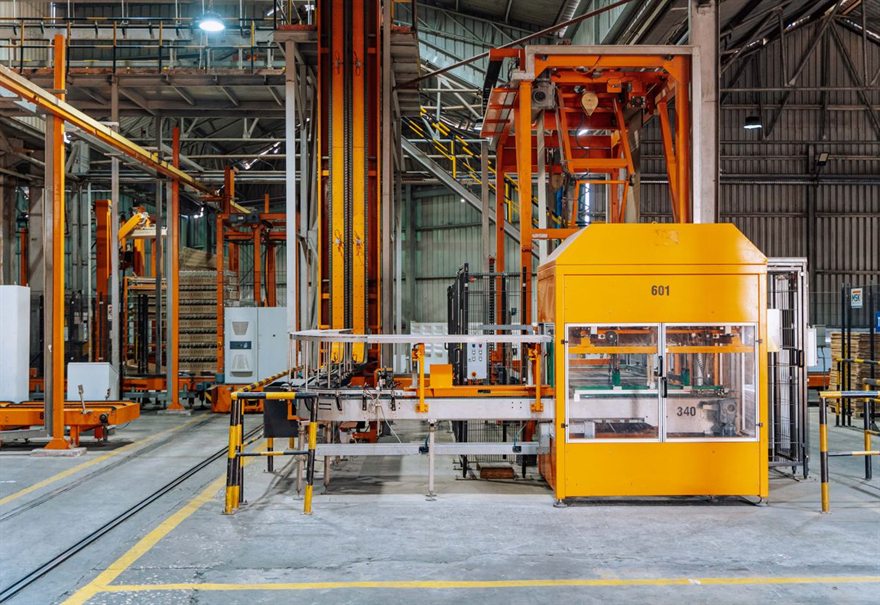 Purpose-built handling and conveyor station on a factory floor